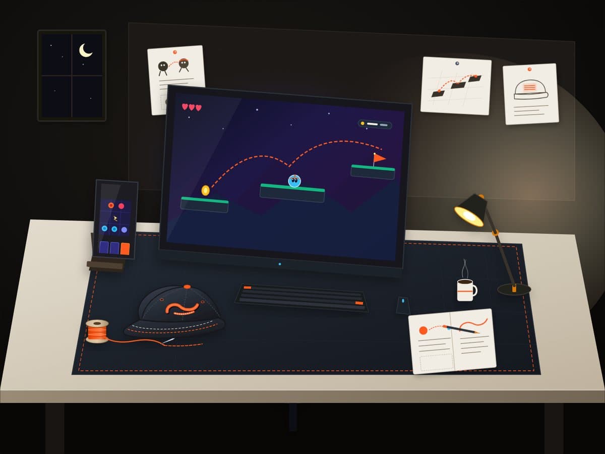 Illustration of a one-person game studio desk at night: a monitor and a phone showing games, an embroidered cap and a thread spool